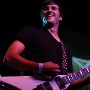 Joe (owner) playing guitar at a show